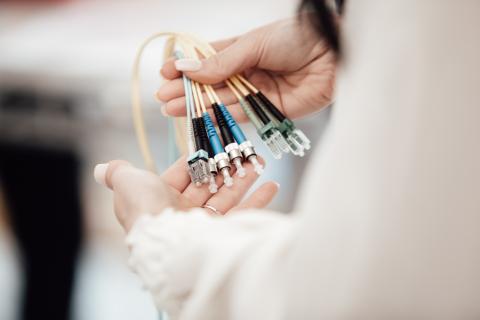 a person holding connection cables