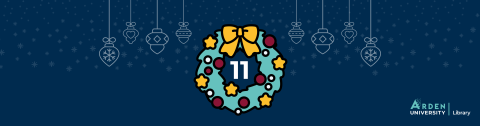 A festive wreath with a number eleven in the centre on a dark blue background with snowflakes and hanging baubles