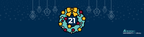 A festive wreath with a number twenty one in the centre on a dark blue background with snowflakes and hanging baubles