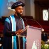 Dr Tru Powell accepting his honorary doctorate from Arden University